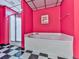 Bright bathroom with a white soaking tub, tiled floors, and bold red walls at 275 Frances Rd, Canton, GA 30114