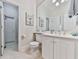 Bright bathroom with white cabinets, a toilet and a decorative mirror at 275 Frances Rd, Canton, GA 30114