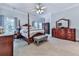 Bedroom with a four poster bed, neutral color palette, sitting bench and dark wood furniture at 275 Frances Rd, Canton, GA 30114