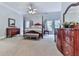 Spacious primary bedroom with a four-poster bed, dark wood furniture, and a neutral color palette at 275 Frances Rd, Canton, GA 30114