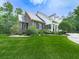 Brick home with a well-manicured lawn, mature trees, and lush shrubbery at 275 Frances Rd, Canton, GA 30114