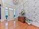 Welcoming foyer with hardwood floors, stylish wallpaper, and chandelier offers a great first impression at 275 Frances Rd, Canton, GA 30114