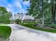 Charming brick home featuring well-manicured landscaping and a long driveway, surrounded by mature trees at 275 Frances Rd, Canton, GA 30114