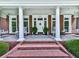 Charming front porch features brick steps, white columns, and porch swings, creating an inviting entrance to the home at 275 Frances Rd, Canton, GA 30114