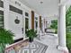 Covered porch featuring a rocking chair, decorative rug, and potted plants enhance the home's inviting curb appeal at 275 Frances Rd, Canton, GA 30114