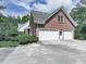 Lovely brick home featuring a large three car garage and lots of driveway space for parking at 275 Frances Rd, Canton, GA 30114