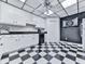Bright kitchen area features white cabinets, sleek black countertops, and a checkerboard-patterned floor at 275 Frances Rd, Canton, GA 30114