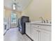 Bright laundry room with white cabinets, a sink, front load washer and dryer at 275 Frances Rd, Canton, GA 30114