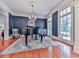 Elegant living room with hardwood floors, chandelier, and piano offers a sophisticated space for entertaining guests at 275 Frances Rd, Canton, GA 30114