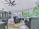 Relaxing screened porch featuring comfortable seating and ceiling fan overlooking the wooded backyard at 275 Frances Rd, Canton, GA 30114