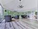 Beautiful screened-in porch with plank flooring, ample seating, and wooded views at 275 Frances Rd, Canton, GA 30114