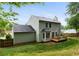Light green two-story house featuring a deck and partially fenced-in yard at 5859 Bellingrath Way, Lithonia, GA 30058