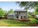Exterior view of backyard showing deck, lawn and surrounding trees at 5859 Bellingrath Way, Lithonia, GA 30058