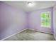 Cozy bedroom with soft carpet, light purple walls, and natural light at 5859 Bellingrath Way, Lithonia, GA 30058