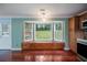 Bright breakfast nook with bay window, bench seating, wood floors and backyard views at 5859 Bellingrath Way, Lithonia, GA 30058