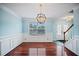 Charming dining room with wood floors, wainscoting, and decorative lighting fixture at 5859 Bellingrath Way, Lithonia, GA 30058
