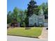 Charming two-story home with manicured lawn, neat landscaping, and attached garage at 5859 Bellingrath Way, Lithonia, GA 30058
