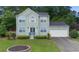Charming two-story home with a well-manicured lawn and attached two-car garage at 5859 Bellingrath Way, Lithonia, GA 30058