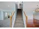 Welcoming entryway with staircase, hardwood and carpeted flooring, and elegant lighting at 5859 Bellingrath Way, Lithonia, GA 30058