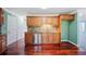 Contemporary kitchen with stainless steel appliances, wood cabinets, and hardwood floors at 5859 Bellingrath Way, Lithonia, GA 30058