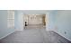 Spacious living room featuring carpet flooring, fireplace, and stylish columns at 5859 Bellingrath Way, Lithonia, GA 30058