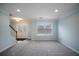 Bright living room with carpet flooring, double-door entrance, and ample natural light at 5859 Bellingrath Way, Lithonia, GA 30058