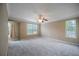 Spacious main bedroom featuring neutral walls, ceiling fan, and large windows at 5859 Bellingrath Way, Lithonia, GA 30058