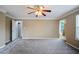 Large main bedroom offers a ceiling fan, plush carpeting, and an arched window at 5859 Bellingrath Way, Lithonia, GA 30058