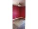 Bedroom features damaged hardwood floors, pink walls, and a ceiling fan at 637 Ferris St, Atlanta, GA 30310