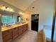 Primary bathroom featuring a double sink vanity, bathtub, and linen closet at 842 Treeline Dr, Conyers, GA 30016