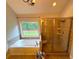 Primary bathroom featuring a jacuzzi tub, shower, and large window at 842 Treeline Dr, Conyers, GA 30016