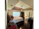 Bedroom with a tray ceiling, fan, and dark wood floors at 842 Treeline Dr, Conyers, GA 30016