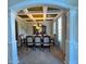 Elegant dining room boasts coffered ceiling, view of modern chandelier, and seating for eight at 842 Treeline Dr, Conyers, GA 30016