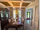 Elegant dining room with coffered ceilings, modern chandelier, and a beautiful china cabinet at 842 Treeline Dr, Conyers, GA 30016