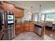 Well-equipped kitchen with stainless steel appliances, granite countertops and open dining area at 842 Treeline Dr, Conyers, GA 30016