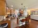 Well-lit kitchen features stainless appliances, granite counters, island with seating, and wood cabinetry at 842 Treeline Dr, Conyers, GA 30016