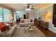 Bright living room with large windows, ceiling fan, and comfortable seating at 842 Treeline Dr, Conyers, GA 30016