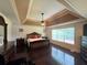 Beautiful primary bedroom with tray ceilings, fan, and hardwood floors at 842 Treeline Dr, Conyers, GA 30016