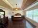 Spacious primary bedroom with tray ceilings, fan, and large window at 842 Treeline Dr, Conyers, GA 30016