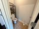 Efficiently designed half bathroom with tiled floors and practical shelving at 842 Treeline Dr, Conyers, GA 30016