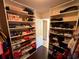 Organized walk-in closet featuring white shelves stocked with shoes and accessories at 842 Treeline Dr, Conyers, GA 30016
