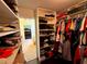 Well-organized walk-in closet with shelves displaying shoes, bags, and a variety of clothing items at 842 Treeline Dr, Conyers, GA 30016