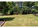 Spacious, manicured backyard with mature trees and an iron fence at 960 River Valley Dr, Dacula, GA 30019