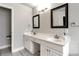 Bright bathroom with double vanity, sleek mirrors, and modern fixtures set against neutral walls at 960 River Valley Dr, Dacula, GA 30019