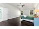 Serene main bedroom with dark wood floors, natural light, and an ensuite bathroom at 960 River Valley Dr, Dacula, GA 30019