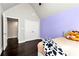Bedroom boasts hardwood floors, purple accent wall and large closet at 960 River Valley Dr, Dacula, GA 30019