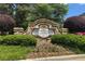 Stone entrance sign to The Terraces at Apalachee Farms surrounded by manicured bushes at 960 River Valley Dr, Dacula, GA 30019