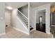 Home entryway and staircase with dark wood treads and white risers at 960 River Valley Dr, Dacula, GA 30019