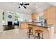 Bright kitchen with island seating, granite countertops, and light wood cabinets open to the living room at 960 River Valley Dr, Dacula, GA 30019