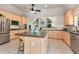 Spacious kitchen featuring wood cabinets, stainless steel appliances, granite countertops, and a center island at 960 River Valley Dr, Dacula, GA 30019